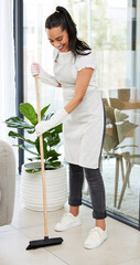 Wall Mural - I make it a habit to clean my house on weekends. Full length shot of an attractive young woman standing and using a broom to sweep her home.