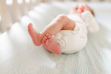 newborn baby feet in crib