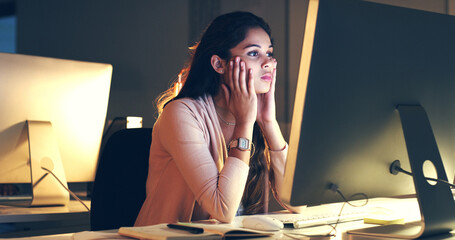 Poster - Shes trying hard to focus. Cropped shot of a beautiful young woman working at night in a modern office.