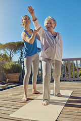 Poster - Improving health in the golden years. Shot of a senior woman doing yoga with an instructor on a patio outside.