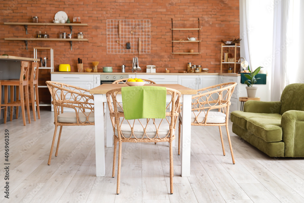 Stylish interior of kitchen with dining table and chairs