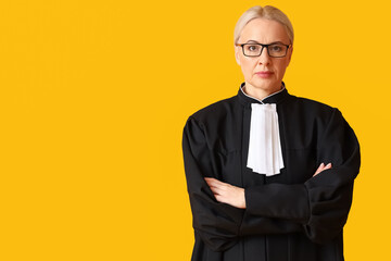 Poster - Mature female judge in robe on yellow background