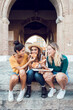 © Xavier Lorenzo - Vertical shot of happy multiracial women eating pizza in city street - Three diverse female tourist having fun on summer holidays in Italy - Friendship and vacation concept