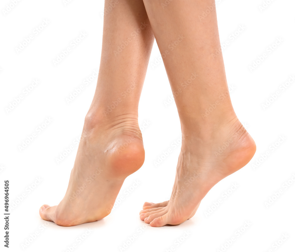 Female bare feet on white background, closeup