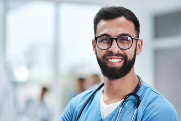 Ive found fulfilment in my profession. Portrait of a young medical practitioner standing in a hospital.