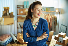 Smiling Trendy Business Owner Woman In Office In Blue Overall