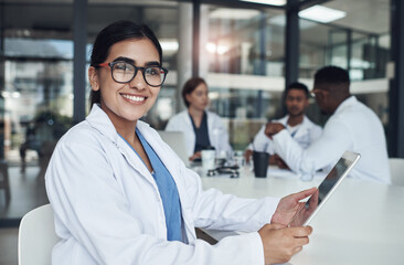 Aufkleber - taking some time to indulge in some internet. Shot of a young female doctor using her digital tablet.