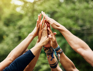 Sticker - Time for some outdoor fun. Shot of a group of unrecognizable peoples hands raised in the air to form a huddle together outside during the day.