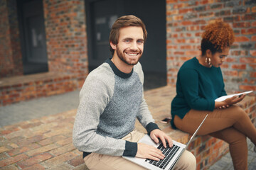 Sticker - Getting some fresh air while studying. High angle shot of two young university students using a laptop to study on campus.