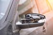 © Tricky Shark - Broken side mirror plastic cover close up.  Damaged car mirror with wires sticking out from vandals and hooligans. Repair car after accident concept