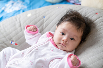 asian newborn baby kid eye contact with mom cuteness of children with happy family on soft mattress 