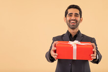 Portrait Of A Happy Businessman Holding Gift In Hand