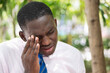 Black African man suffering from irritated eye, eye pain, eye infection, optical health care concept
