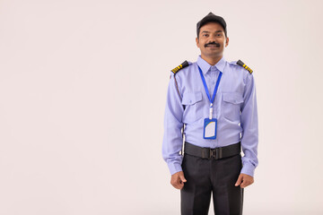 Wall Mural - Portrait of male security guard standing in uniform