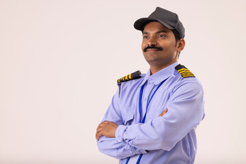 Wall Mural - Portrait of Security guard looking elsewhere with arms folded