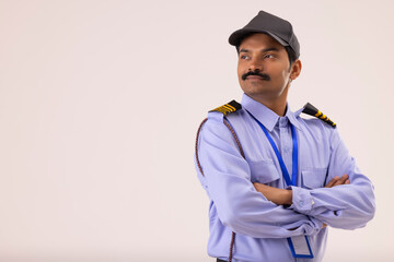 Wall Mural - Portrait of Security guard looking elsewhere with arms folded