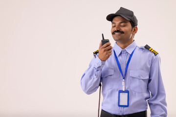 Wall Mural - Portrait of Security guard talking over walkie talkie