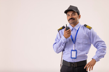 Wall Mural - Portrait of Security guard talking over walkie talkie