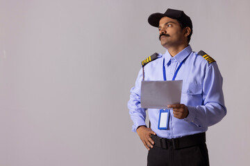 Wall Mural - Security guard looking away with holding papers in hand