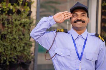 Wall Mural - Portrait of a male security guard saluting