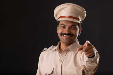 Wall Mural - Close-up portrait of an Indian policeman pointing with finger