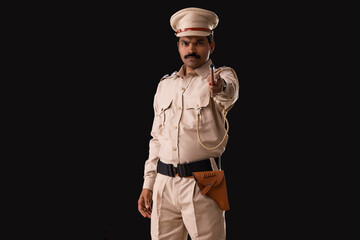 Wall Mural - Portrait of an Indian policeman pointing with baton