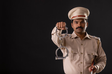 Wall Mural - Portrait of an Indian policeman with handcuffs