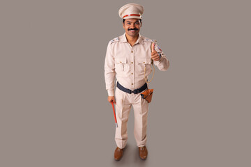 Wall Mural - Top angle view of an Indian policeman showing thumb gesture