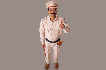 Wall Mural - Top angle view of an Indian policeman showing thumb gesture