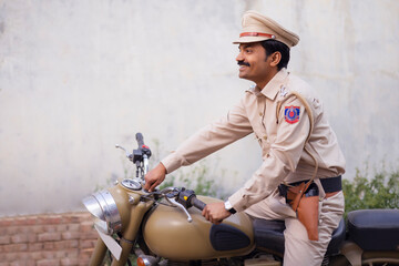 Wall Mural - Portrait of an Indian policeman on bike