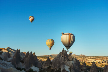 Balloons over tuff houses in a valley in Cappadocia.
Balloons in the sky in Cappadocia in Turkey. Flying colorful multicolored balloons in the sky