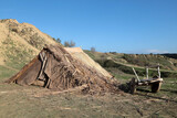 Fototapeta  - A reed tent on a mountain slope. There are old furniture and fire in front of the tent. Istanbul, Turkey.