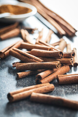 Wall Mural - Dry cinnamon sticks on kitchen table. Cinnamon spice.