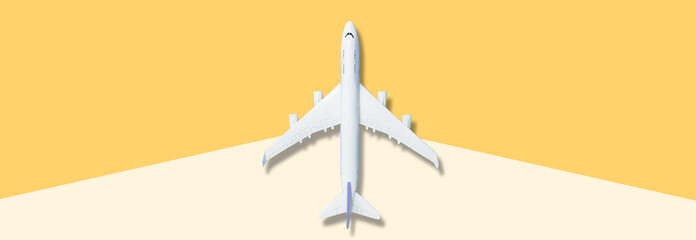 White airplane on blue background, top view, creative concept of air transportation, tourism, travel. Copy space for text