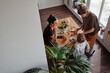 © AnnaStills - High angle view of lesbian family having breakfast at table with their little son