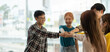 © Natee Meepian - diverse group of asian business partner fist bump in modern office. Colleague partnership teamwork, university student, congratulation event, job or mission accomplish concept