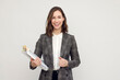 © Martin Villadsen - Beautiful and smiling business woman with paperwork in hand, standing isolated on white, looking happy and smiling to the camera.