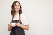 © Martin Villadsen - Beautiful young barista woman smiling and serving a cup of coffee. Isolated on white background looking professional.
