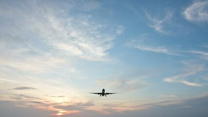 Wall Mural - 4K Overhead flying aircraft landing at sunset or sunrise