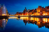 Fototapeta Niebo - Beautiful architecture of Gdansk old town reflected in the Motlawa river at dusk, Poland