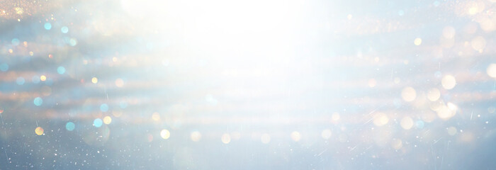 background of abstract gold, blue and silver glitter lights. defocused
