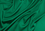 Fototapeta  - Green satin fabric as background