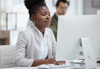 Poster - Finishing up her deadlines with determination. Shot of a young businesswoman working on a computer in an office.
