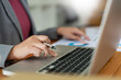 © snowing12 - Business analyst concept the data analyst holding and pointing her pen at the document about sale chart