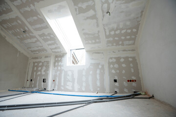 Wall Mural - Attic finishing construction site in the phase drywall spackling and plastering before screeding