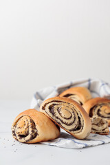 Wall Mural - Homemade poppy seed roll buns on a white table