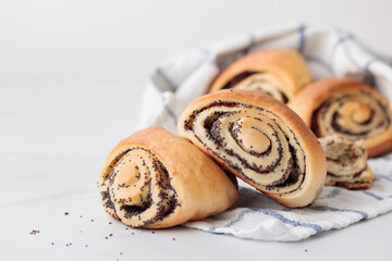 Wall Mural - Homemade poppy seed roll buns on a white table