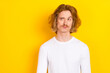 Photo of hesitant young man looking empty space brainstorming find solution isolated on yellow color background