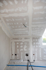 Wall Mural - Attic finishing construction site in the phase drywall spackling and plastering before screeding