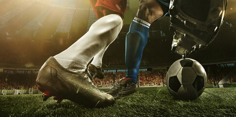 Close-up legs of soccer, football players in action, motion at the stadium with flashlights and crowded stands. Concept of sport, competition, movement, overcoming.